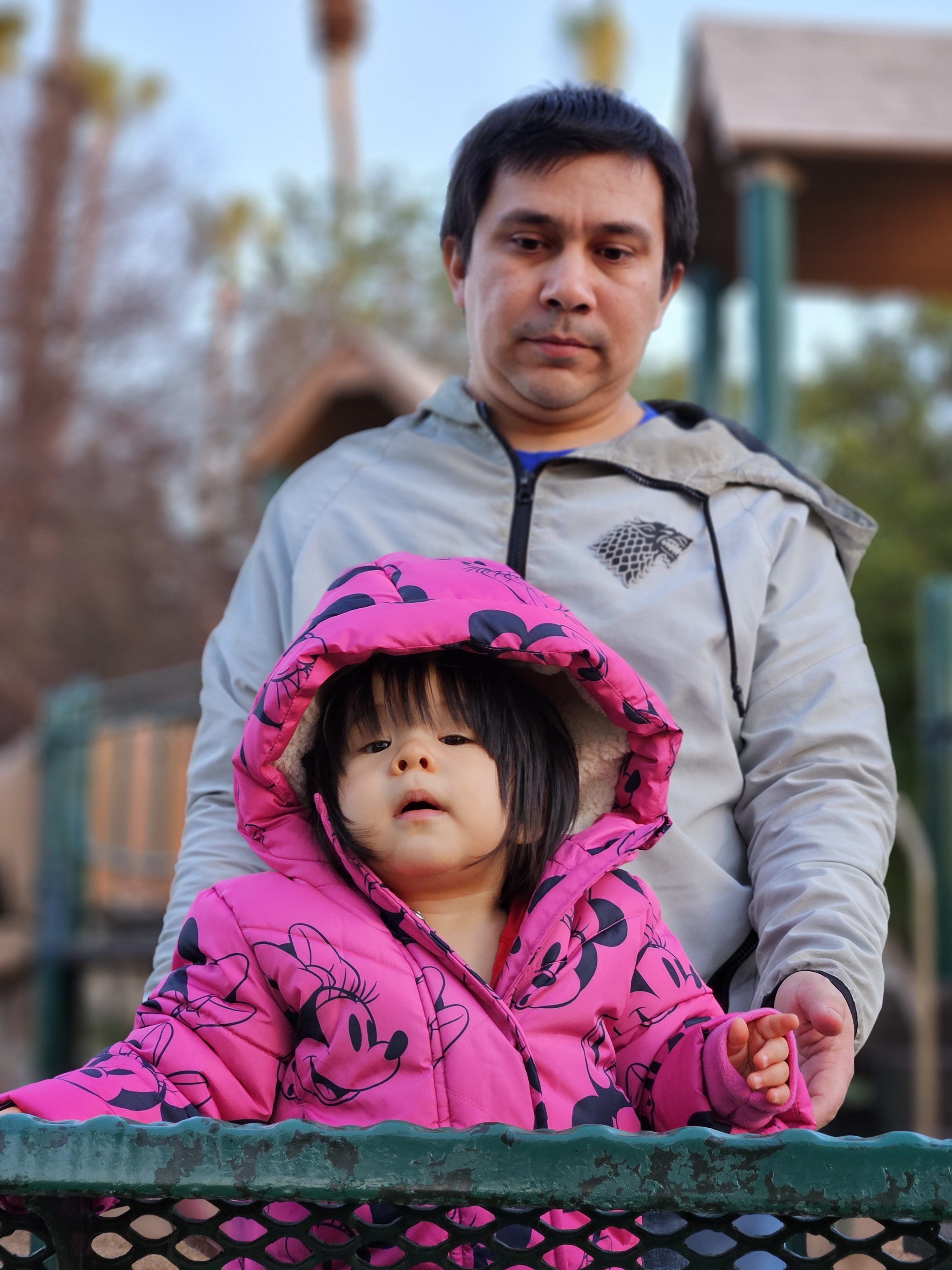 Portrait mode shot of a toddler and her dad
